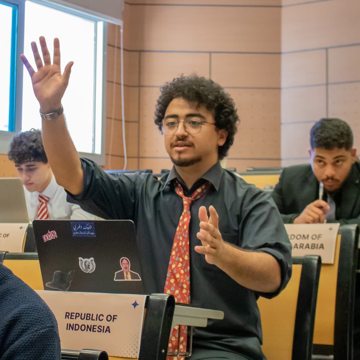 NIMUN delegate raising his hand during a committee session